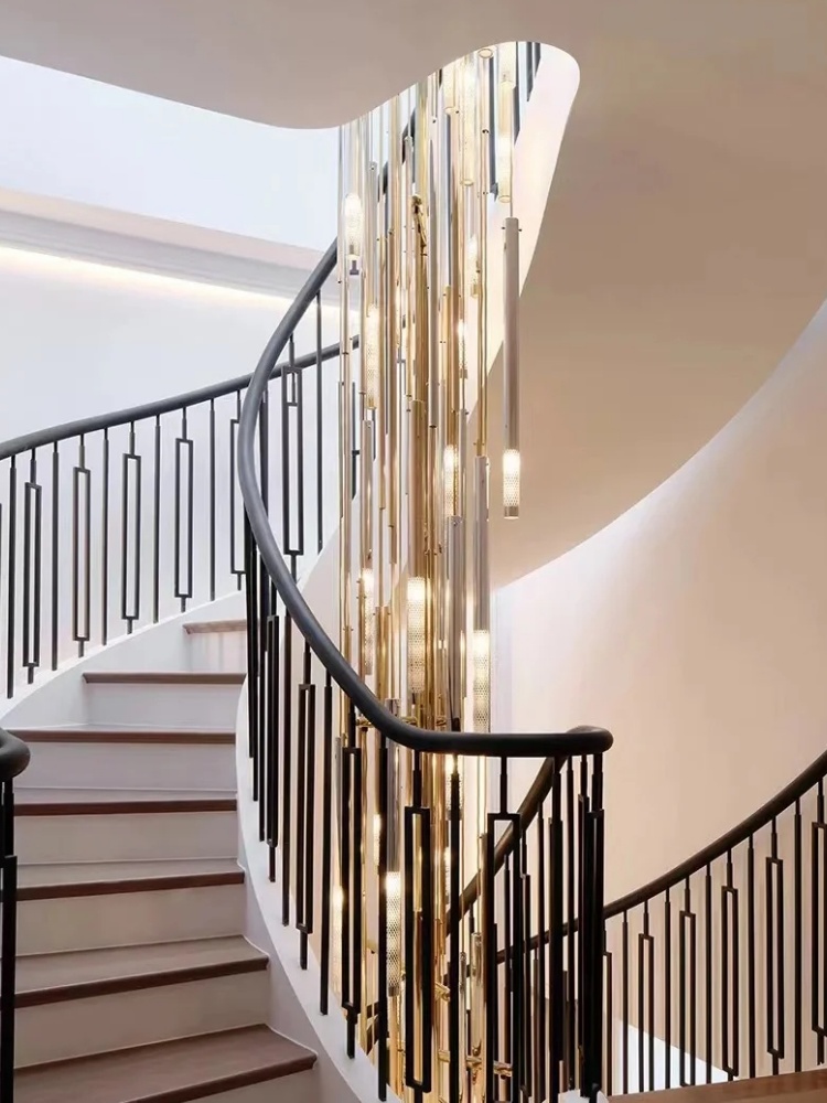Vertical chandelier following the curve of an open stairwell