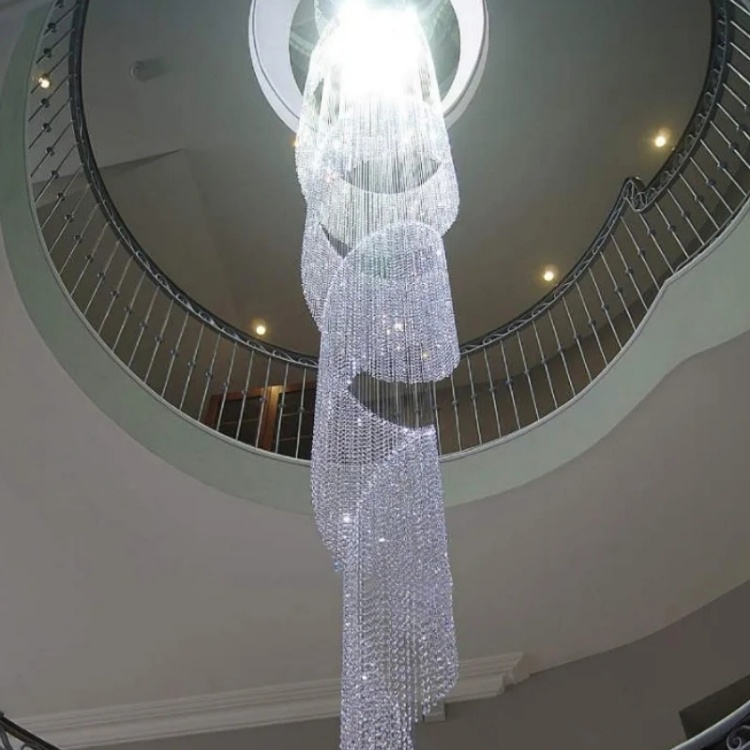 Twisting ribbon of clear faceted drops within a curved stairwell