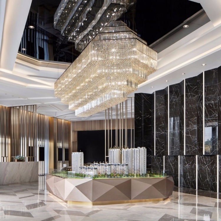 Stepped rectangular chandelier above an architectural display model